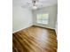 Bedroom with wood look floors, ceiling fan, and large window at 306 Mountain Laurel Walk, Canton, GA 30114