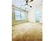 Bedroom featuring neutral carpeting, a ceiling fan, window, and closet access at 306 Mountain Laurel Walk, Canton, GA 30114