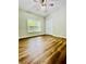Bedroom with wood look floors, ceiling fan, and large window at 306 Mountain Laurel Walk, Canton, GA 30114