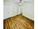 Bedroom with wood look floors, ceiling fan, and double door closet at 306 Mountain Laurel Walk, Canton, GA 30114