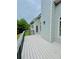 Deck view featuring blue siding, white trim, and views of a mature tree line at 306 Mountain Laurel Walk, Canton, GA 30114