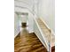 A welcoming entryway featuring hardwood floors and a staircase with white railings at 306 Mountain Laurel Walk, Canton, GA 30114