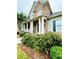 Charming two-story home with a stone facade, covered porch and landscaped front yard at 306 Mountain Laurel Walk, Canton, GA 30114