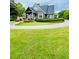 Charming curb appeal with a landscaped front yard and circular driveway at 306 Mountain Laurel Walk, Canton, GA 30114