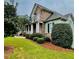 Charming home featuring stone accents, a well-manicured lawn, and beautiful landscaping at 306 Mountain Laurel Walk, Canton, GA 30114