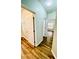 Hallway with wood look floors leading to several rooms at 306 Mountain Laurel Walk, Canton, GA 30114