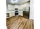 The open concept kitchen features tile backsplash and stainless appliances at 306 Mountain Laurel Walk, Canton, GA 30114