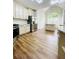 Bright kitchen featuring white cabinets, stainless steel appliances, and beautiful hardwood floors at 306 Mountain Laurel Walk, Canton, GA 30114