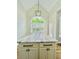 Kitchen island with granite countertop, white cabinets, black hardware, and pendant lighting at 306 Mountain Laurel Walk, Canton, GA 30114