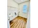 Laundry room with utility sink, shelving, and vinyl flooring at 306 Mountain Laurel Walk, Canton, GA 30114