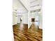 Open-concept living room with high ceilings, wood floors, and stone fireplace at 306 Mountain Laurel Walk, Canton, GA 30114