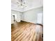 A spacious main bedroom has a tray ceiling, ceiling fan and wood-look floors at 306 Mountain Laurel Walk, Canton, GA 30114