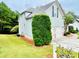 Home featuring light siding, white trim, garage, and landscaped yard with green lawn at 306 Mountain Laurel Walk, Canton, GA 30114