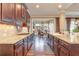 Spacious kitchen with granite countertops, dark wood cabinets, and breakfast area at 8025 Georgetown Cir, Suwanee, GA 30024