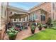 Brick patio with seating area, umbrella, and lush landscaping at 8025 Georgetown Cir, Suwanee, GA 30024