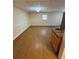Open basement area with wood-look flooring, neutral paint and natural light from the window at 294 Puckett Se Rd, Emerson, GA 30137