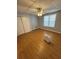 Bright bedroom with wood laminate floors, a ceiling fan, and a large window for natural light at 294 Puckett Se Rd, Emerson, GA 30137