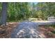 Spacious driveway leading to a home, framed by lush trees and greenery at 294 Puckett Se Rd, Emerson, GA 30137