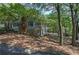 Charming home with a brick chimney and a inviting covered porch surrounded by lush greenery at 294 Puckett Se Rd, Emerson, GA 30137