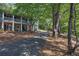 A home with a long driveway, stone facade, and a covered porch, surrounded by lush trees at 294 Puckett Se Rd, Emerson, GA 30137