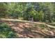 Spacious backyard featuring mature trees and charming shed, perfect for outdoor activities and relaxation at 294 Puckett Se Rd, Emerson, GA 30137