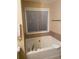 Relaxing bathroom with soaking tub, tile surround, and updated fixtures at 6922 Magnolia Park Dr, Norcross, GA 30093