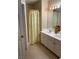 Bright bathroom featuring double vanity, shower, and updated flooring at 6922 Magnolia Park Dr, Norcross, GA 30093