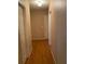 Long hallway with hardwood floors and neutral walls at 6922 Magnolia Park Dr, Norcross, GA 30093