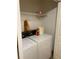 Convenient laundry room with washer, dryer, and overhead shelving at 6922 Magnolia Park Dr, Norcross, GA 30093