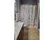 A well-lit bathroom features tiled floors, a neutral shower curtain, and a wood vanity at 898 Oak Sw St # 3108, Atlanta, GA 30310
