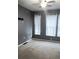 This bedroom offers three windows dressed with white sheer curtains for privacy and light control at 898 Oak Sw St # 3108, Atlanta, GA 30310