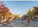 Gated entrance to the community with brick pillars, iron gates, and colorful fall foliage at 898 Oak Sw St # 3108, Atlanta, GA 30310