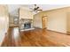 Living room with hardwood floors, stone fireplace and ceiling fan at 2805 Bridle Se Path, Conyers, GA 30094