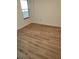 Simple bedroom with hardwood floors and large window at 3982 Woodridge Way, Tucker, GA 30084