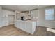 Bright white kitchen with a center island, stainless steel appliances, and plenty of counter space at 3941 Adler Cir, Buford, GA 30519