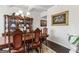 Formal dining room with dark wood table and hutch at 916 Dexter Dr, Stockbridge, GA 30281