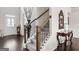 Elegant entryway with staircase, hardwood floors, and decorative accents at 916 Dexter Dr, Stockbridge, GA 30281