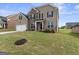 Two-story house with brick facade, large yard and attached garage at 916 Dexter Dr, Stockbridge, GA 30281