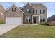 Brick two-story house with a large front yard at 916 Dexter Dr, Stockbridge, GA 30281