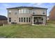 Rear view of home showcasing patio and yard at 916 Dexter Dr, Stockbridge, GA 30281