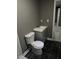 Newly renovated bathroom with gray vanity and dark tile floor at 130 Taunton Rd, Covington, GA 30014