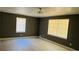 Spacious bedroom with two windows and light wood flooring at 130 Taunton Rd, Covington, GA 30014