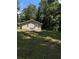 Back view of the house showing a spacious backyard and trees at 130 Taunton Rd, Covington, GA 30014