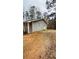 Ranch style home with a gravel driveway and mature trees at 130 Taunton Rd, Covington, GA 30014