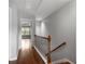 Upstairs hallway with wood floors and a wrought iron railing at 5317 Concordia Pl, Mableton, GA 30126