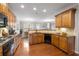 Modern kitchen with wood cabinets, granite countertops, and stainless steel appliances at 5317 Concordia Pl, Mableton, GA 30126