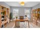 Home office with built-in bookshelves and hardwood floors at 5317 Concordia Pl, Mableton, GA 30126