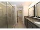 Bathroom with double vanity, large shower, and grey tile at 1129 Red Oak Blvd, Loganville, GA 30052