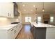 Open concept kitchen with island, white cabinets, and marble countertops at 1129 Red Oak Blvd, Loganville, GA 30052