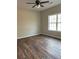 Bedroom with wood flooring, a neutral color scheme, and a large window at 1250 Adamson Rd, Bowdon, GA 30108